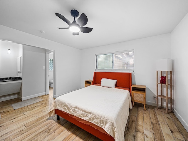 bedroom with baseboards, multiple windows, ceiling fan, and light wood finished floors