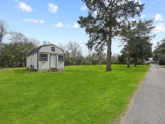 view of yard featuring entry steps and an outbuilding