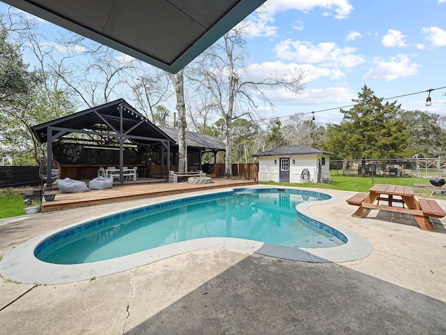 view of swimming pool with an outbuilding, a fenced in pool, a fenced backyard, a gazebo, and a deck