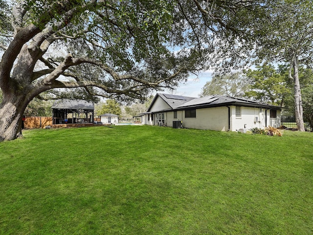 view of yard with a gazebo, cooling unit, and fence