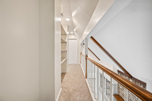 corridor featuring carpet flooring and visible vents