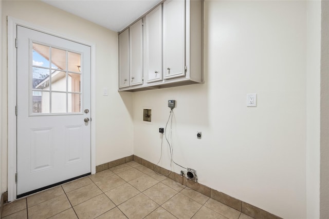 washroom featuring baseboards, washer hookup, light tile patterned flooring, cabinet space, and hookup for an electric dryer