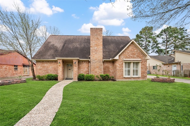 view of front of house with brick siding, a chimney, and a front yard