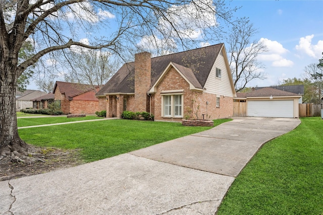 view of front of property featuring a front yard, brick siding, a detached garage, and a chimney