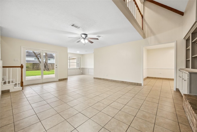 interior space featuring visible vents, built in features, light tile patterned floors, a textured ceiling, and a ceiling fan