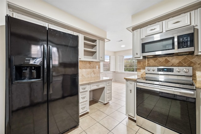 kitchen featuring visible vents, backsplash, light tile patterned floors, stainless steel appliances, and white cabinetry