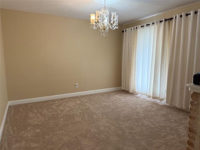 unfurnished room with a chandelier, carpet, and baseboards