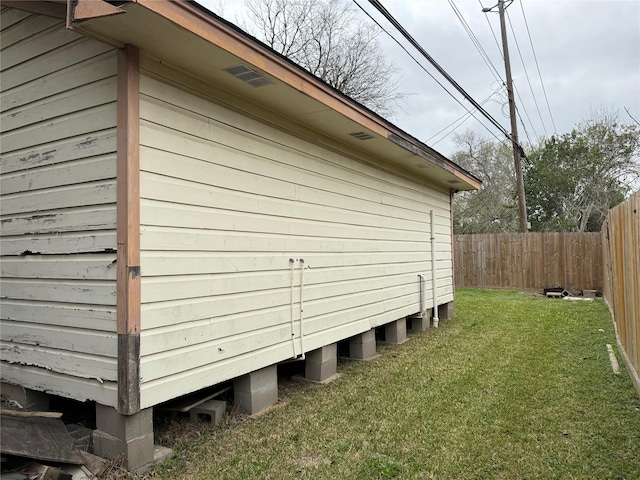 view of home's exterior with a yard and fence