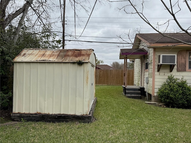 view of shed featuring fence