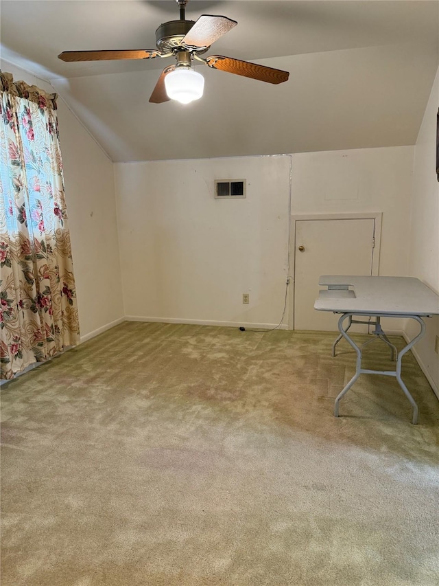 carpeted empty room featuring lofted ceiling and visible vents