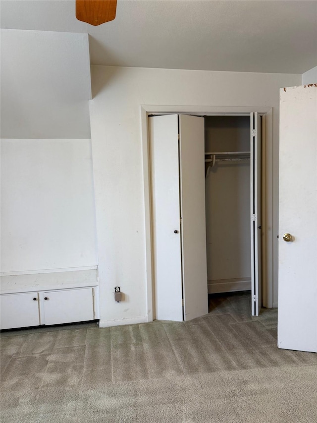 unfurnished bedroom featuring carpet floors and a closet