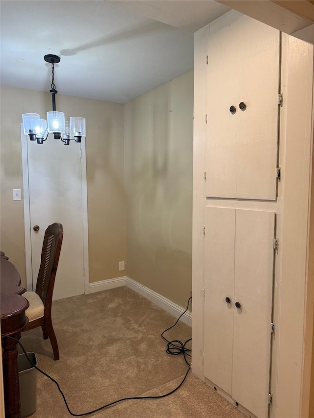 unfurnished office with baseboards, an inviting chandelier, and light colored carpet