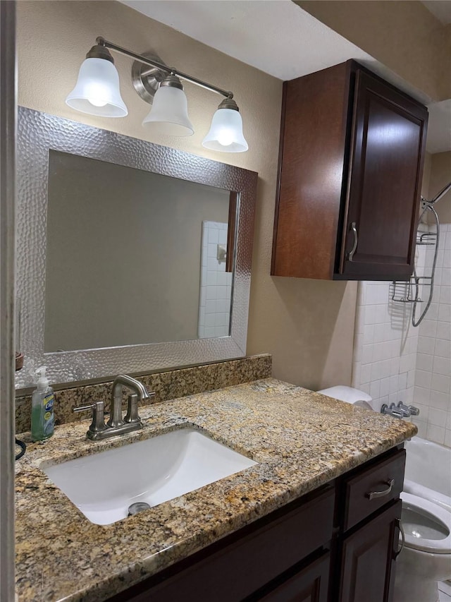 bathroom featuring toilet,  shower combination, and vanity