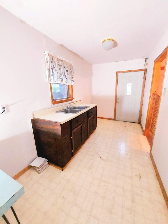 bathroom with tile patterned floors, baseboards, and a sink
