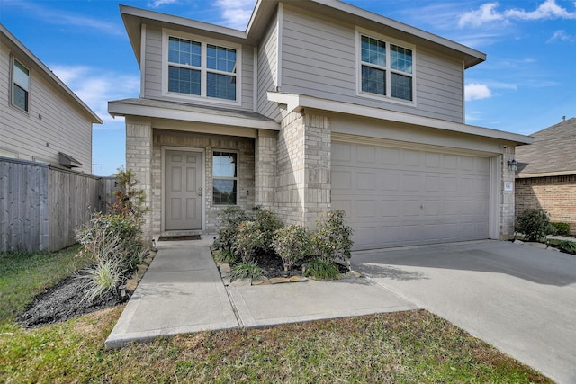 traditional-style house featuring concrete driveway, fence, and an attached garage