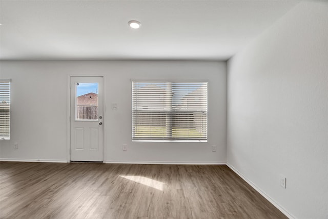 foyer with wood finished floors and baseboards