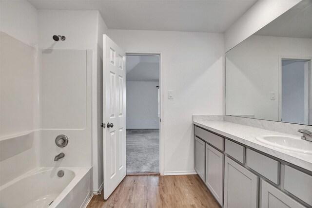 full bathroom with tub / shower combination, wood finished floors, and vanity