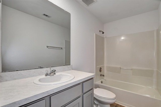 full bathroom featuring toilet, shower / bath combination, vanity, and visible vents