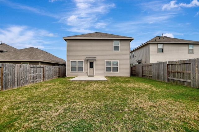 back of property featuring a fenced backyard, a lawn, and a patio