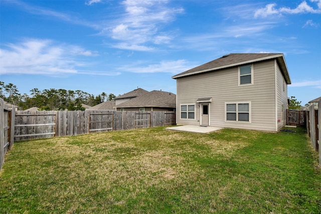 rear view of house featuring a patio area, a fenced backyard, and a lawn