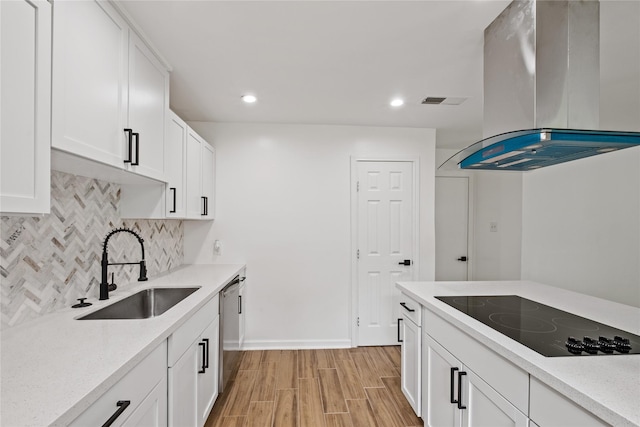 kitchen featuring decorative backsplash, dishwasher, island exhaust hood, black electric cooktop, and a sink