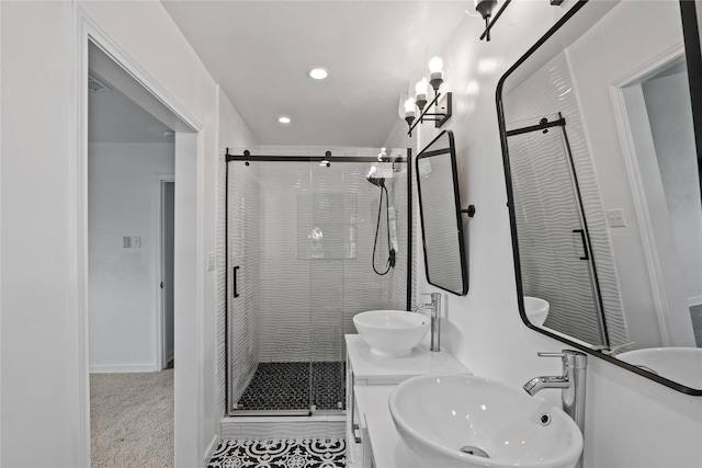 bathroom featuring a stall shower, a sink, and recessed lighting