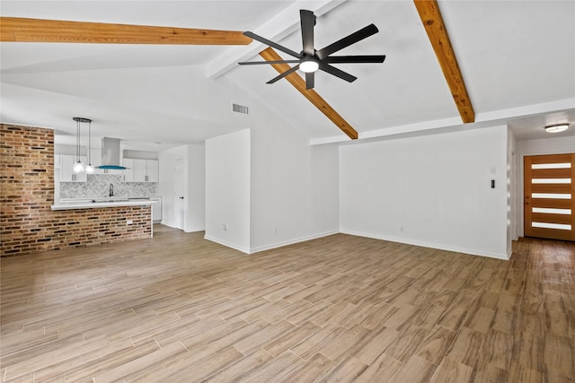 unfurnished living room featuring vaulted ceiling with beams, visible vents, light wood-style floors, ceiling fan, and baseboards