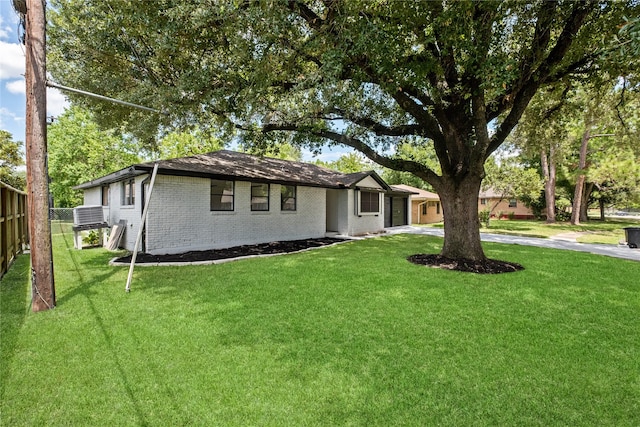 single story home with a front yard, brick siding, driveway, and fence