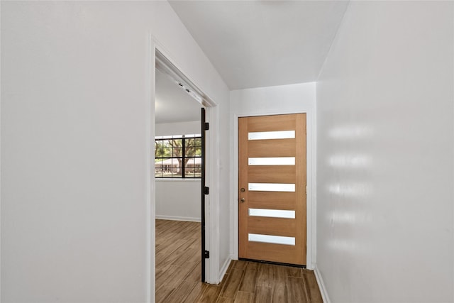 entryway with baseboards and wood finished floors