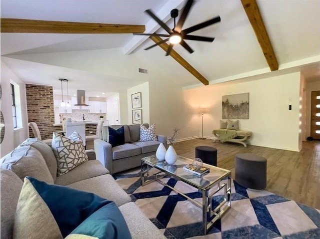 living room featuring beamed ceiling, wood finished floors, visible vents, and a ceiling fan