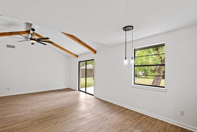 empty room featuring light wood-type flooring, vaulted ceiling with beams, baseboards, and visible vents