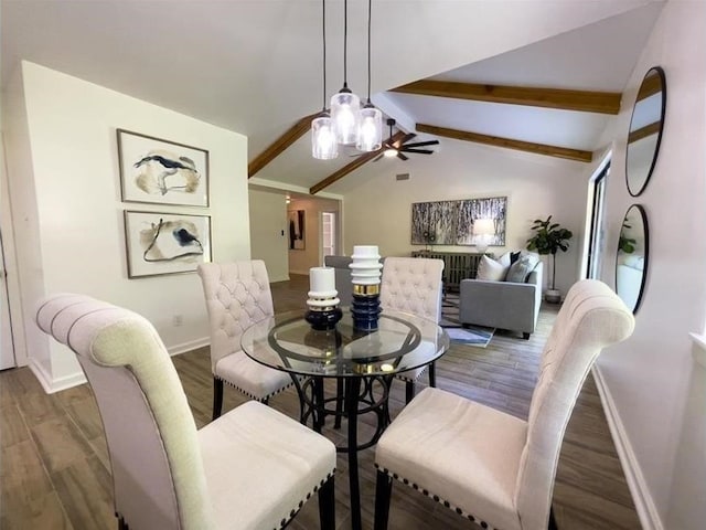 dining room with vaulted ceiling with beams, baseboards, and wood finished floors