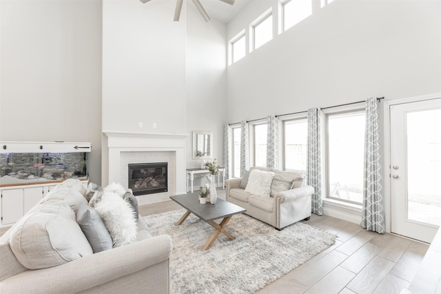 living area featuring a brick fireplace and wood finished floors