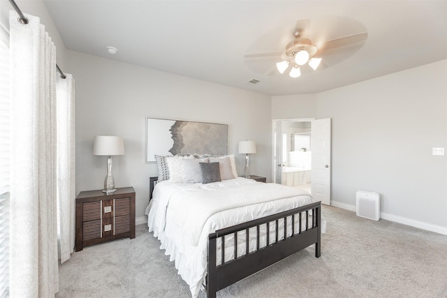 bedroom featuring baseboards, visible vents, a ceiling fan, ensuite bath, and carpet flooring