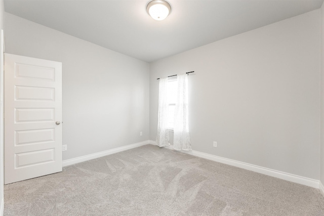 empty room with carpet floors and baseboards