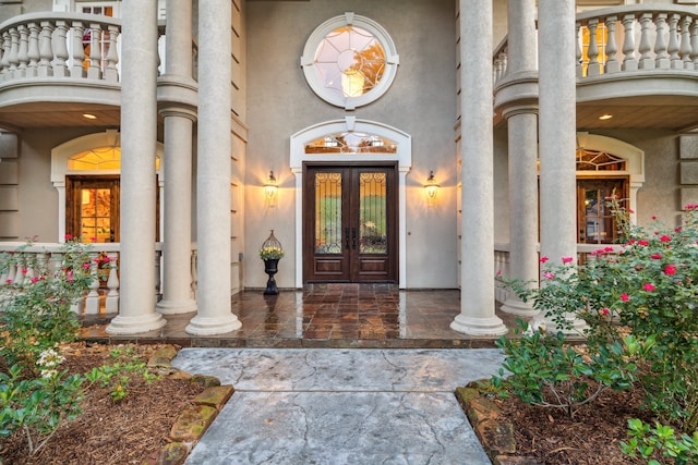 property entrance with french doors and stucco siding