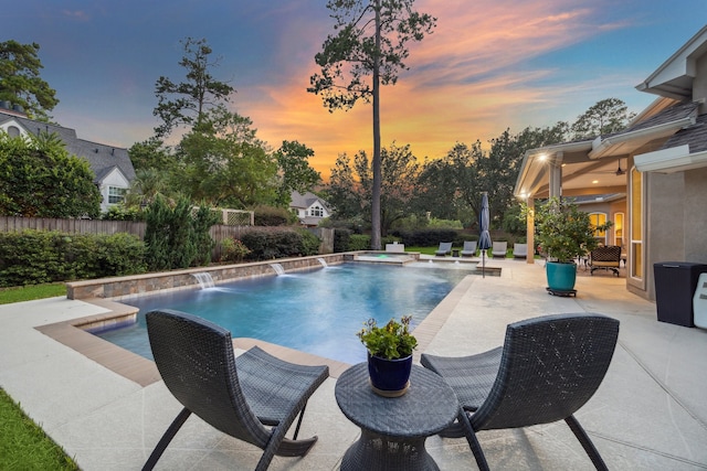 view of swimming pool with an in ground hot tub, a patio, fence, and a fenced in pool