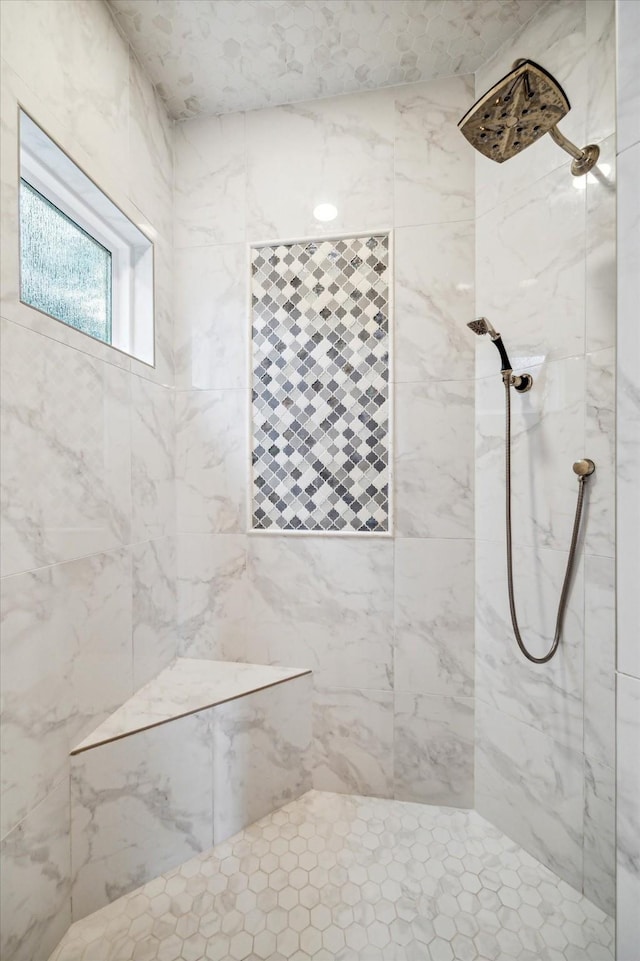 bathroom with a marble finish shower