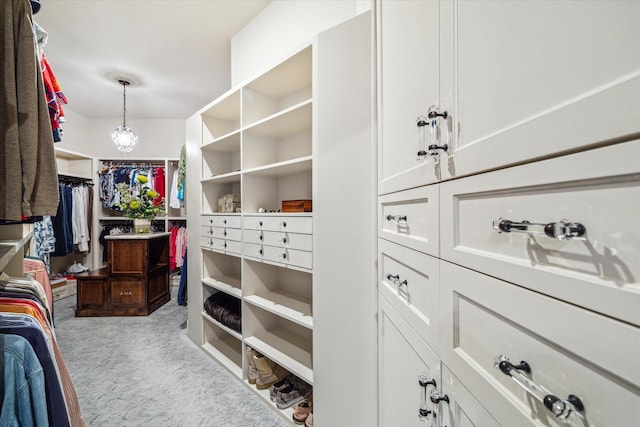 walk in closet with carpet flooring