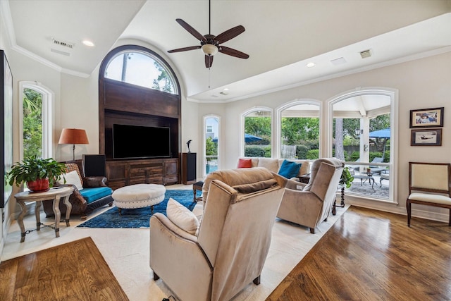 living room featuring a wealth of natural light, ornamental molding, and visible vents