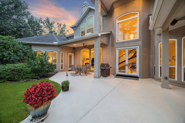 rear view of house featuring stucco siding and a patio