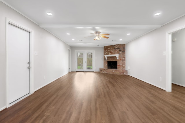 unfurnished living room with a fireplace, wood finished floors, baseboards, and a ceiling fan