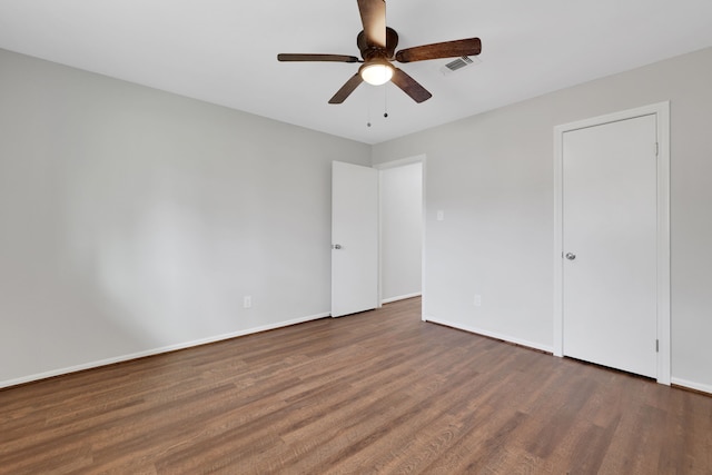 unfurnished bedroom featuring visible vents, a ceiling fan, baseboards, and wood finished floors