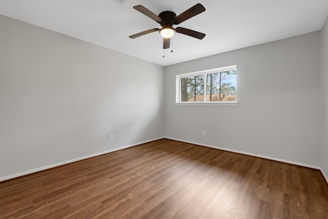 unfurnished room with wood finished floors, baseboards, and ceiling fan