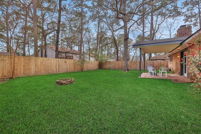 view of yard featuring a patio area and a fenced backyard