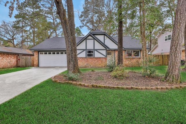 tudor-style house with brick siding, driveway, a garage, and fence