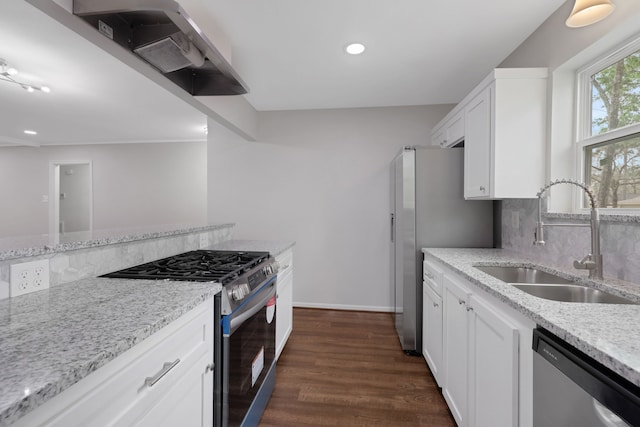 kitchen featuring a sink, backsplash, stainless steel appliances, light stone countertops, and dark wood-style flooring