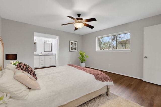 bedroom featuring ceiling fan, baseboards, wood finished floors, and ensuite bathroom