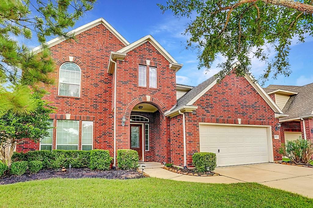 26731 Eagle Park Ln, Katy, TX 77494 - traditional-style home with brick siding, an attached garage, and concrete driveway