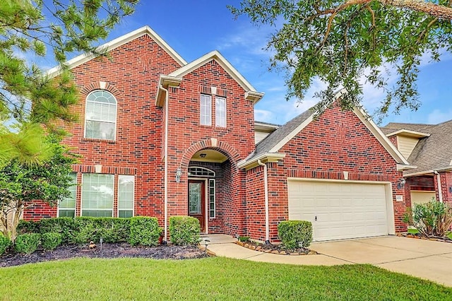 traditional-style home with brick siding, an attached garage, and concrete driveway